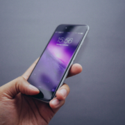 Person using thumb print to unlock iPhone