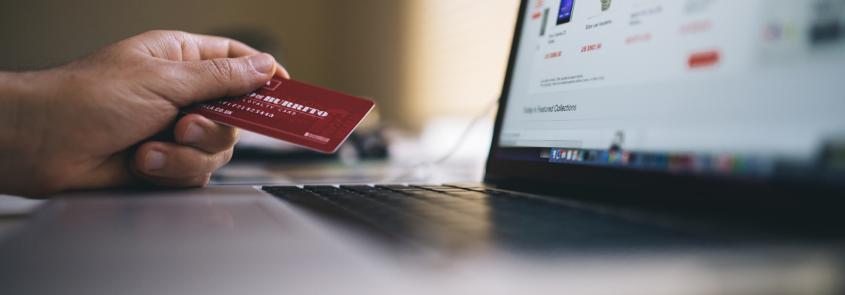 Man using credit card to buy items off Ebay