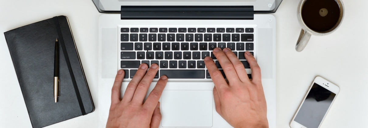 Working on laptop while drinking coffee