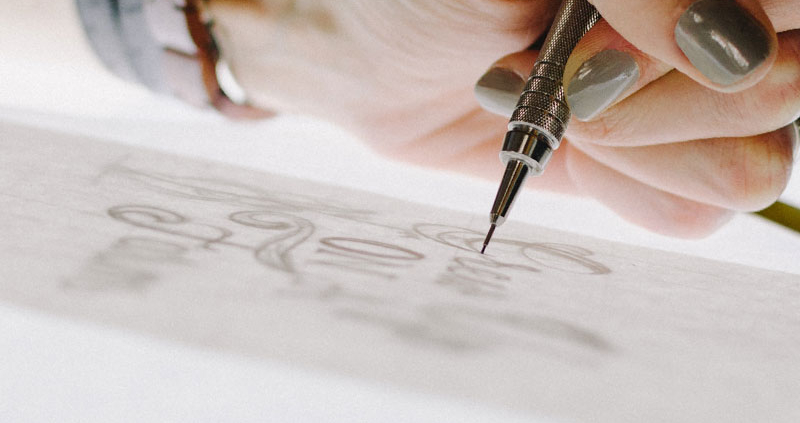 Close up of designer's hand while she sketches