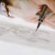 Close up of designer's hand while she sketches
