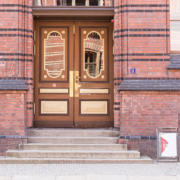 Brown and gold doorway set in brick building