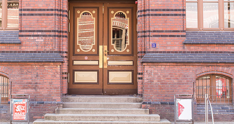 Brown and gold doorway set in brick building