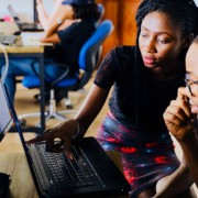 Man and woman looking and pointing at computer screen