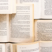 Multiple open books stacked on top of and next to each other