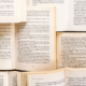 Multiple open books stacked on top of and next to each other