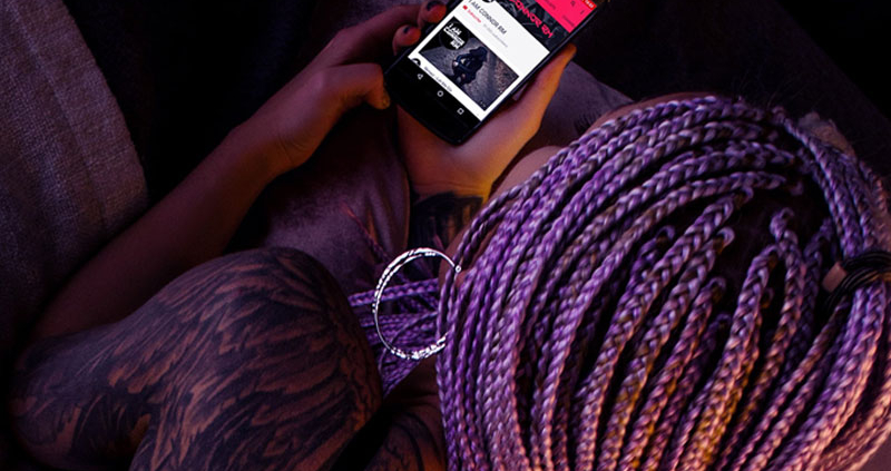 Over the shoulder shot of a woman viewing her mobile phone