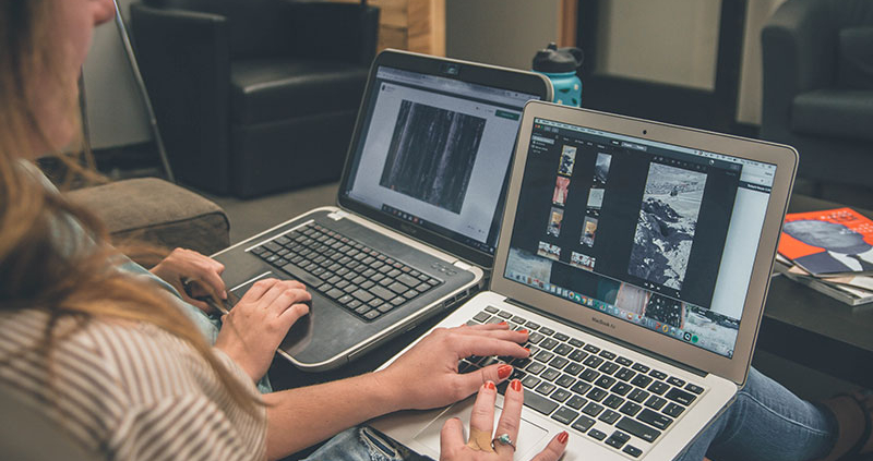 Two people with laptops on their laps browsing online