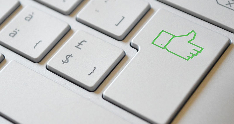 keyboard with enter button replaced by a green thumbs up symbol