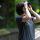 Woman looking through binocculars