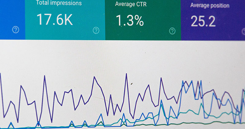 Computer screen showing website statistic percentages and a line graph