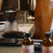 Small business owner in apron making coffee