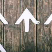 Four white arrows on dark background pointing up