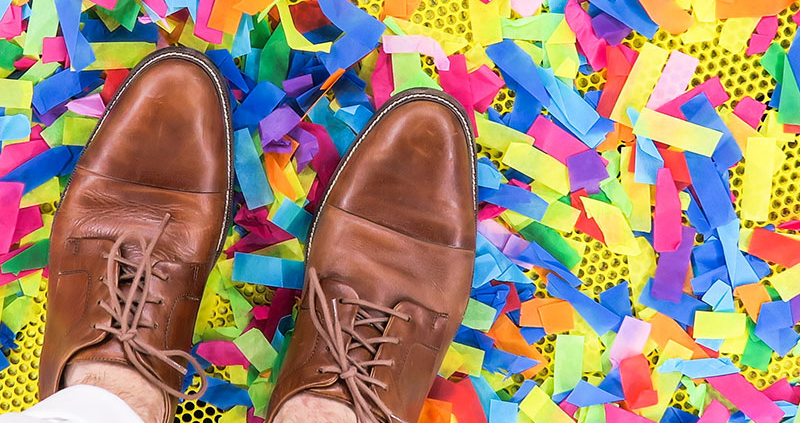 Man standing on confetti filled floor