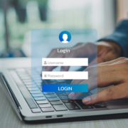Man using keyboard computer laptop interface on touch screen to create username and password inputs for a new business email account.