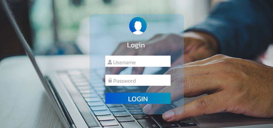 Man using keyboard computer laptop interface on touch screen to create username and password inputs for a new business email account.