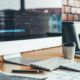 A computer and a coffee cup on the desk of a website designer.