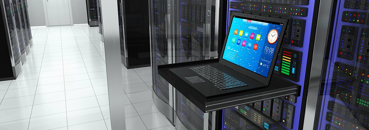 A laptop inside a server room.