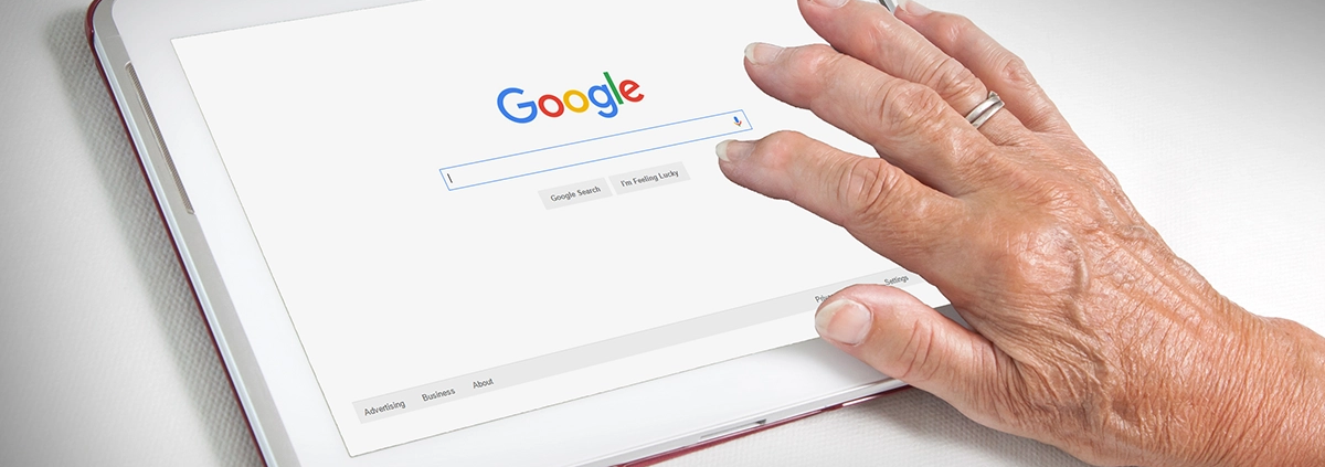 A person searching on Google on a tablet computer.