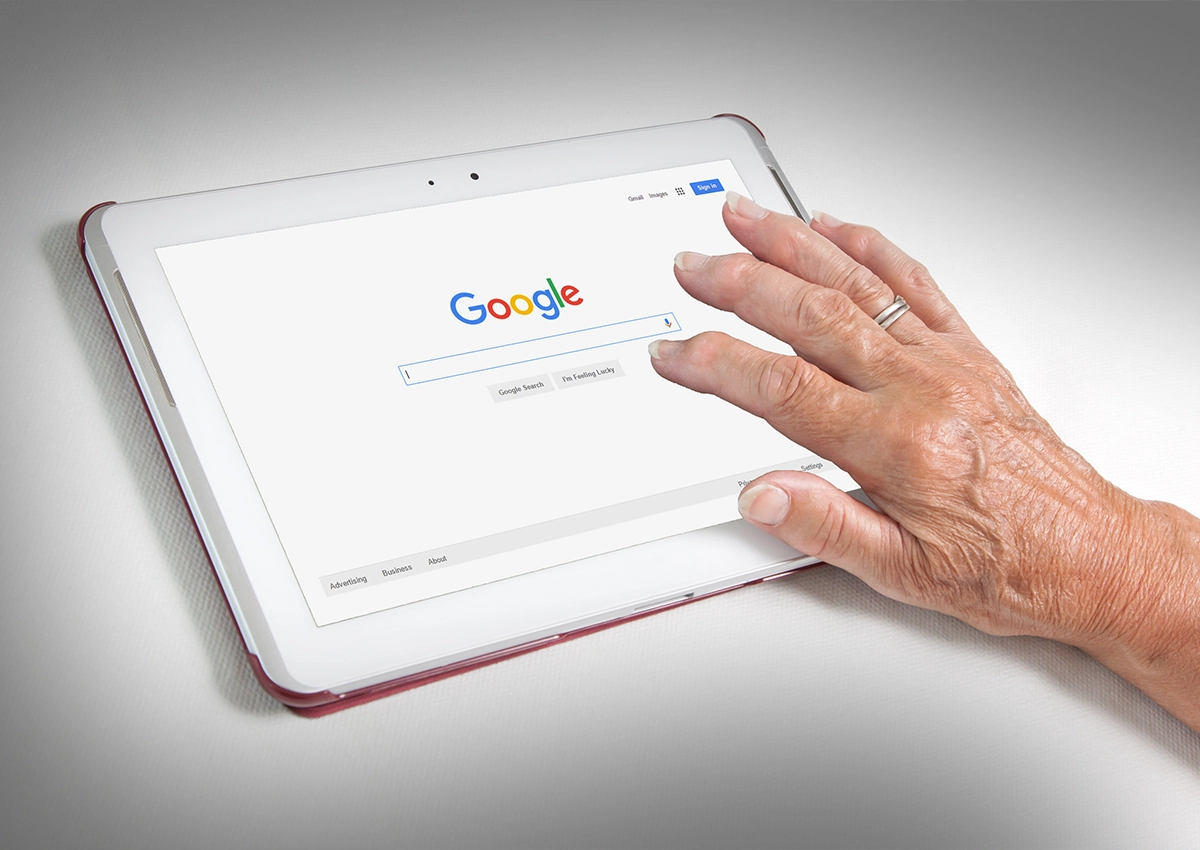 A person searching on Google on a tablet computer.