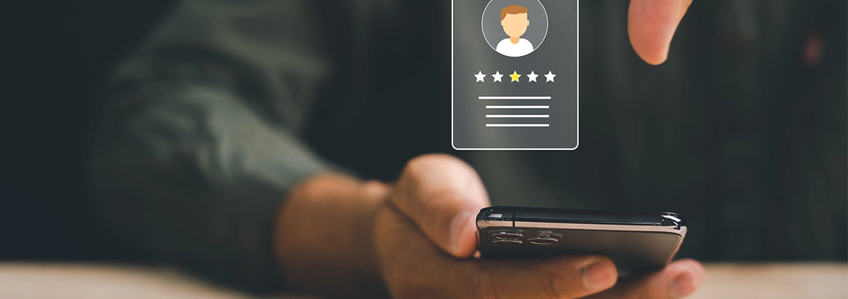 An image depicting a customer leaving a bad review on their phone.