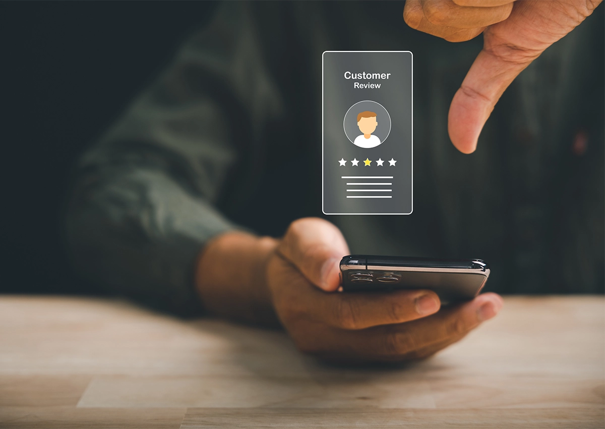 An image depicting a customer leaving a bad review on their phone.