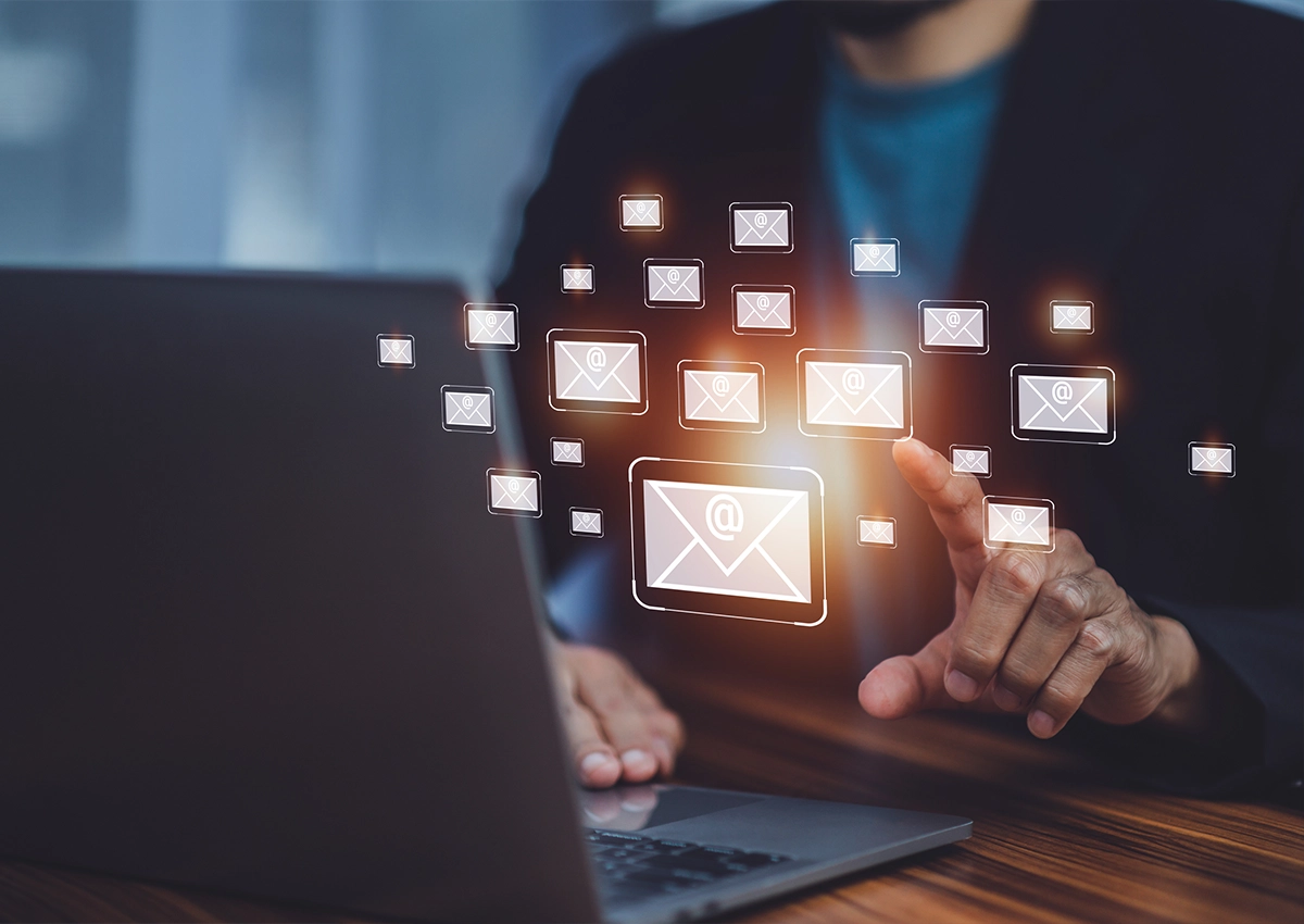 An illustration depicting a man sitting at a laptop opening an email.