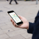 A person holding a cell phone with Google Maps on the screen.
